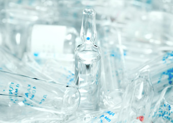 Ampoule containing clear drug with the background of the many br