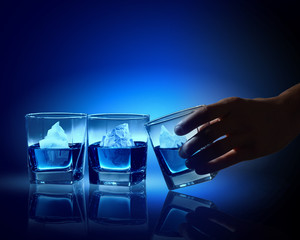 Three glasses of blue liquid