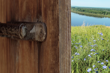 Summer landscape behind the open door