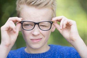 Blond smart teenager boy outdoor