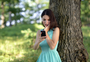 young woman talking on mobile phone in park