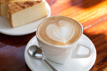 Cup of latte coffee with cake