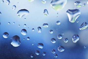 Fresh background of water drops on blue surface