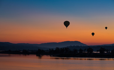 Hot air balloon over the mountain at sunset