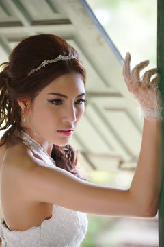 Young Asian lady in white bride dress