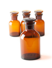 Small chemical glass bottles on white background