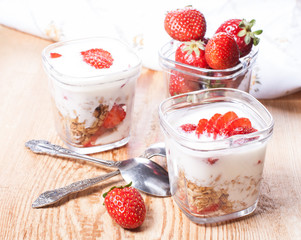 serving of yogurt with granola and strawberries