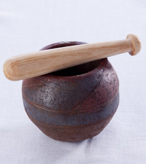 Moroccan Pestle and mortar on a fabric background.