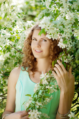 Young woman in blooming garden