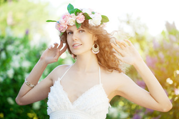 Young beauty woman in blooming garden