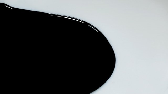 Liquid paints dripping on white paper with matte