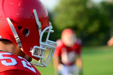 Foto op Plexiglas american football player wearing red helmet © berna_namoglu