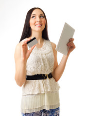 Young girl with credit card and tablet PC