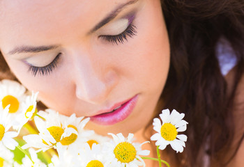 Girl on camomile meadow