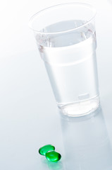 Glass of water and pills isolated