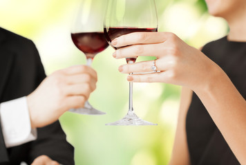 engaged couple with wine glasses