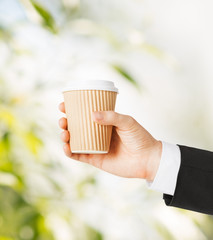man hand holding take away coffee
