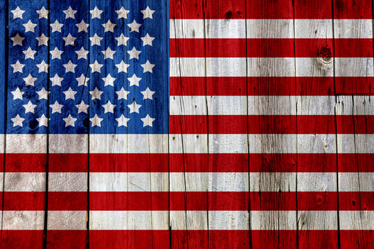 Old Painted American Flag on Dark Wooden Fence