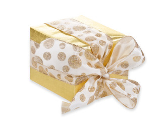 Golden gift wrapped present with dotted bow over white