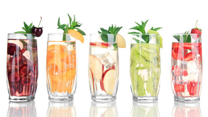 Glasses of fruit drinks with ice cubes isolated on white
