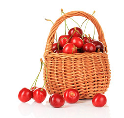 Cherry berries in wicker basket isolated on white