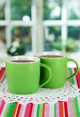 Cups of tea on table in room