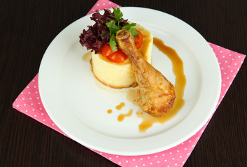 Small portion of food on big plate on wooden table