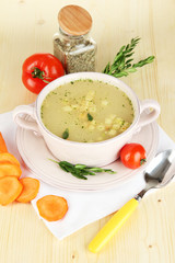 Nourishing soup in pink pan with ingredients