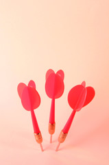 Darts on pink background
