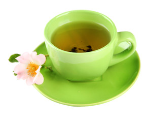 Cup of herbal tea with hip rose flower, isolated on white