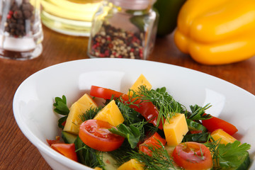 Light salad in plate on wooden table