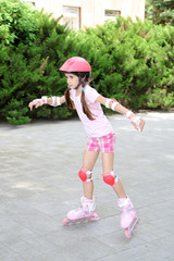 Little girl in roller skates at  park