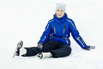 Fototapeta na wymiar Woman sitting on ice skates.