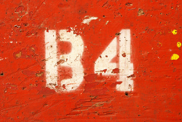 A interesting painted number on a wall in a agriculture barn