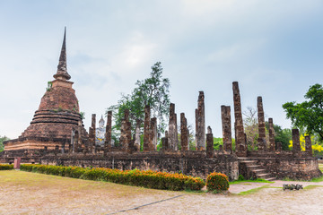 ancient seated buddha staue in the temple ruins