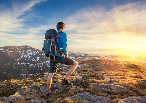 Backpacker On Top Of A Mountaine