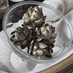 painted in silver color artichokes are in bowl. Decoration.