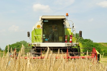 Front view of combine harvester in the wheat field