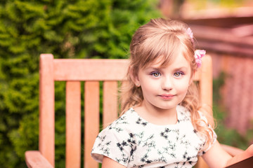 Charming little girl in a beautiful dress outdoor © len44ik