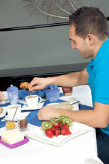 Young man having breakfast