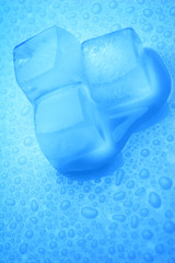 Three ice cubes with drops of water