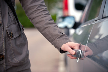 Female hand opening a car door