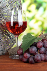 Ripe delicious grapes with glass of wine