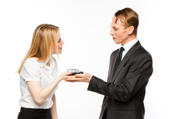 young man and woman are holding a toy car