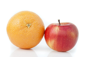 Orange and apple on a white background.