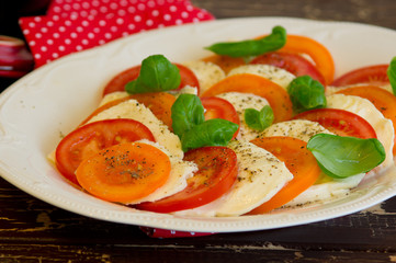 Salad Caprese with tomato and mozzarella cheese