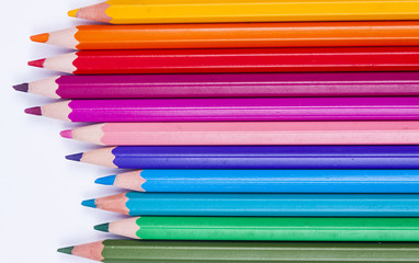 Colourful crayons on white background.