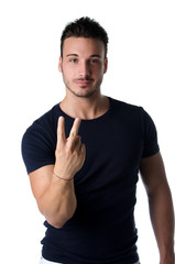 Young man doing British sign for fuck