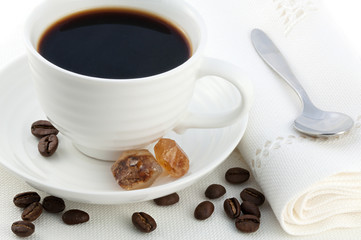 cup of hot black turkish coffee, caramel brown sugar crystals