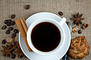 Cup of black coffee, caramel sugar, cinnamon, star anise
